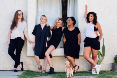 L to R: Rachel Kincaid, Laneia Jones, Riese Bernard, Carmen Phillips, and Sarah Sarwar in front of a window with Carol the dog