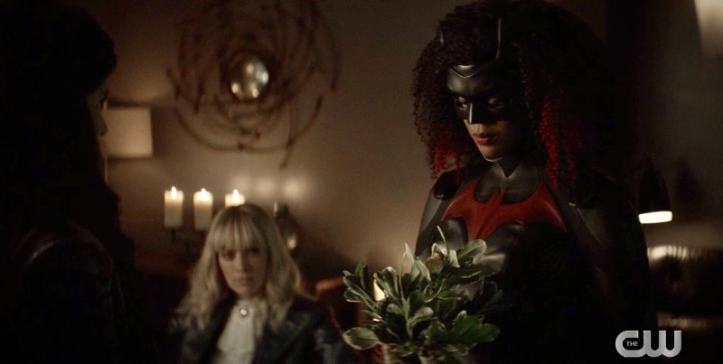 Batwoman presents the Desert Road plant, Alice is in the background