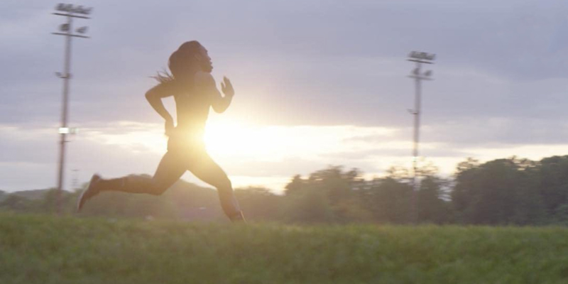 In the documentary Changing the Game, a teenage athlete runs very fast against a blurred sunrise
