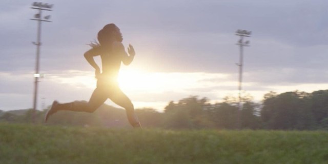 In the documentary Changing the Game, a teenage athlete runs very fast against a blurred sunrise