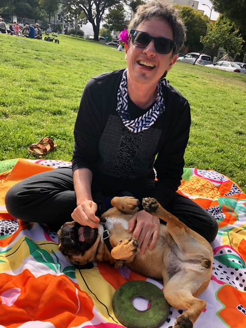 Nabil with a pup on a picnic blanket