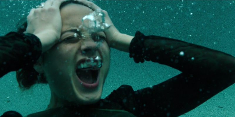 Riley fully dressed in her pool screams underwater hands on her head
