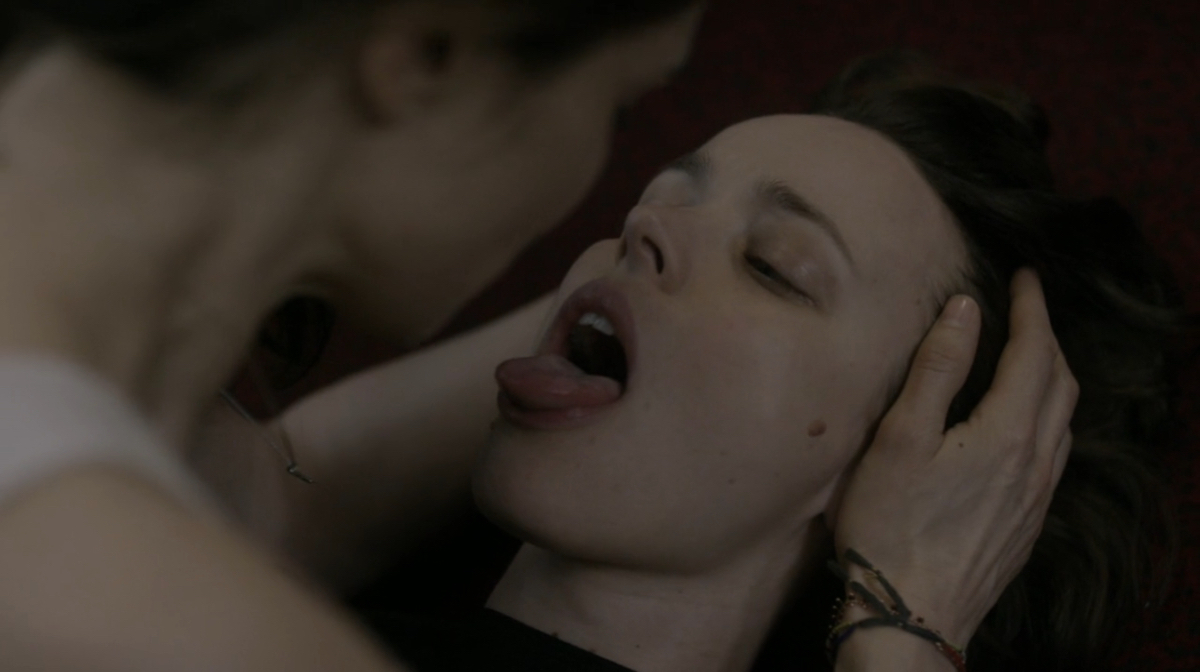Lesbian sex scenes: Rachel McAdams opens her mouth wide and sticks her tongue out as Rachel Weisz spits in her mouth.