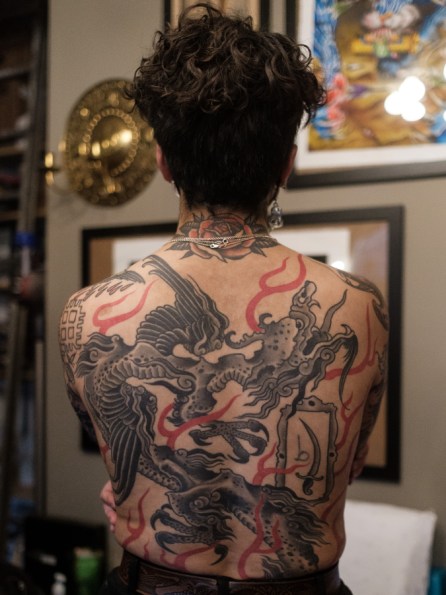 Image shows the heavily tattooed back of Sema.