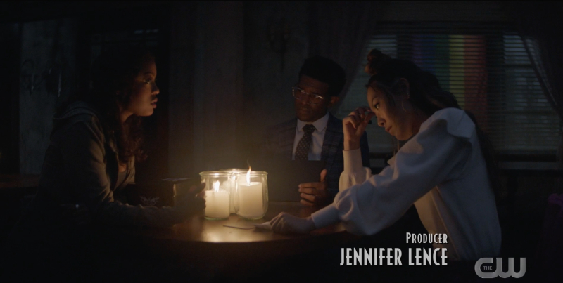 Mary, Luke, and Ryan sit at a table by candlelight, trying to make a plan 
