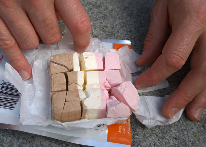 A crumbling square of neopolitan flavoured freeze dried ice cream