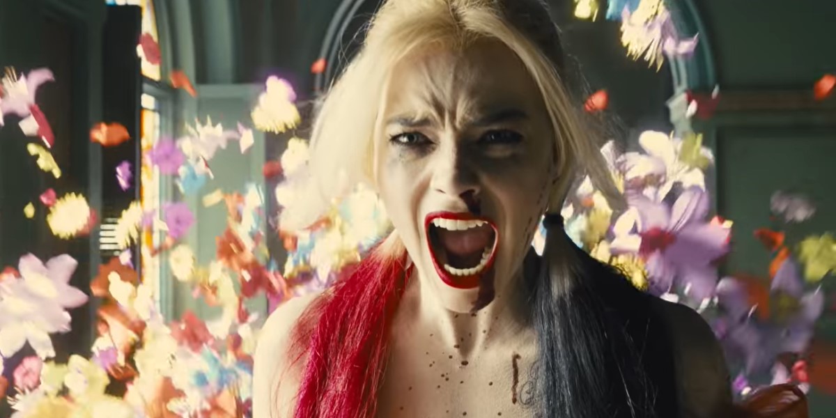 Harley Quinn, bisexual badass, screams as flowers explode around her.
