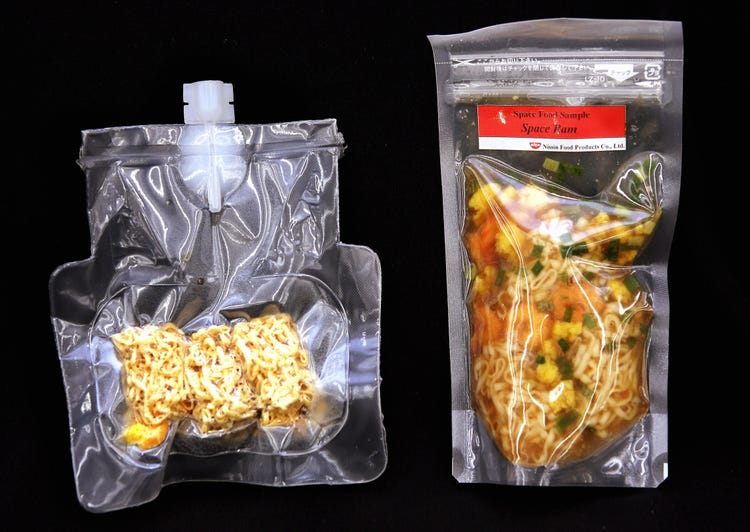 Vacuum packed plastic pouches of cooked noodles for astronauts labeled Space Ram