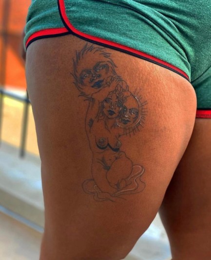 image shows a close up of a tattoo on a Black persons upper thigh.