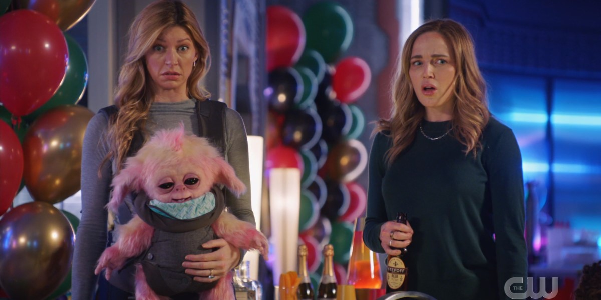 Legends of Tomorrow Episode 609: Avalance, Sara and Ava, at a birthday party looking surprised and holding a baby alien