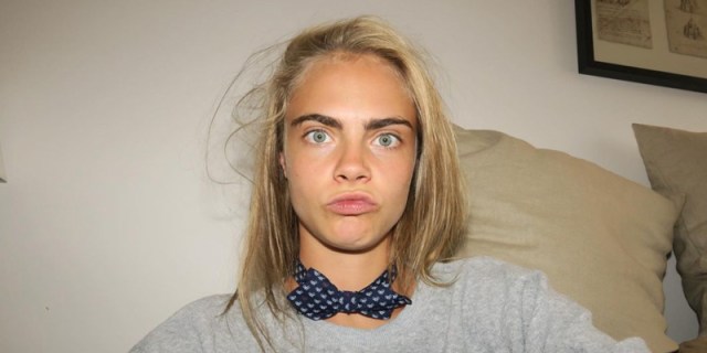 Cara Delevingne in a close up making silly faces with her eyebrows showing prominently