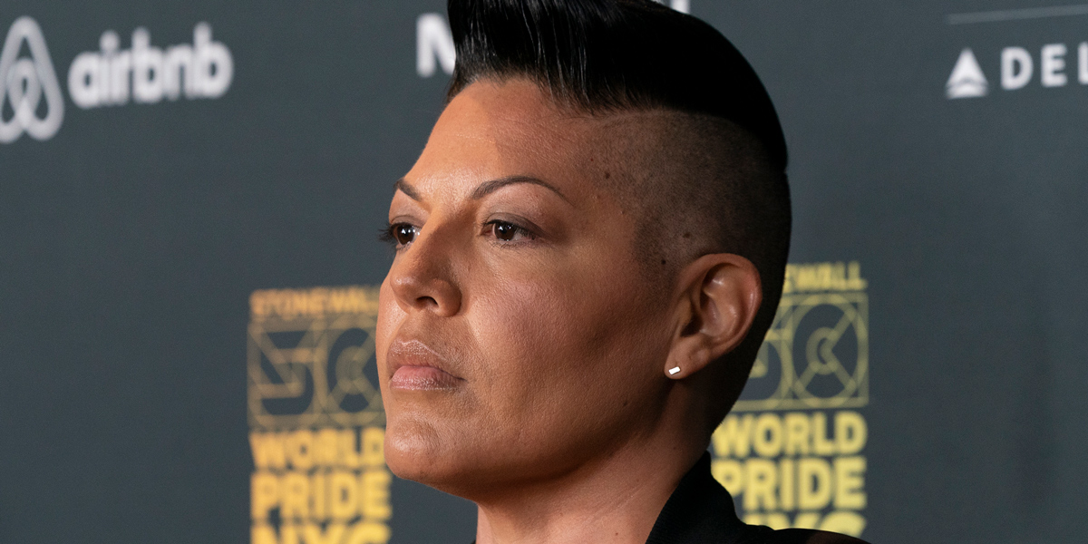 A close up of Sara Ramirez looking very handsome with a strong jawline