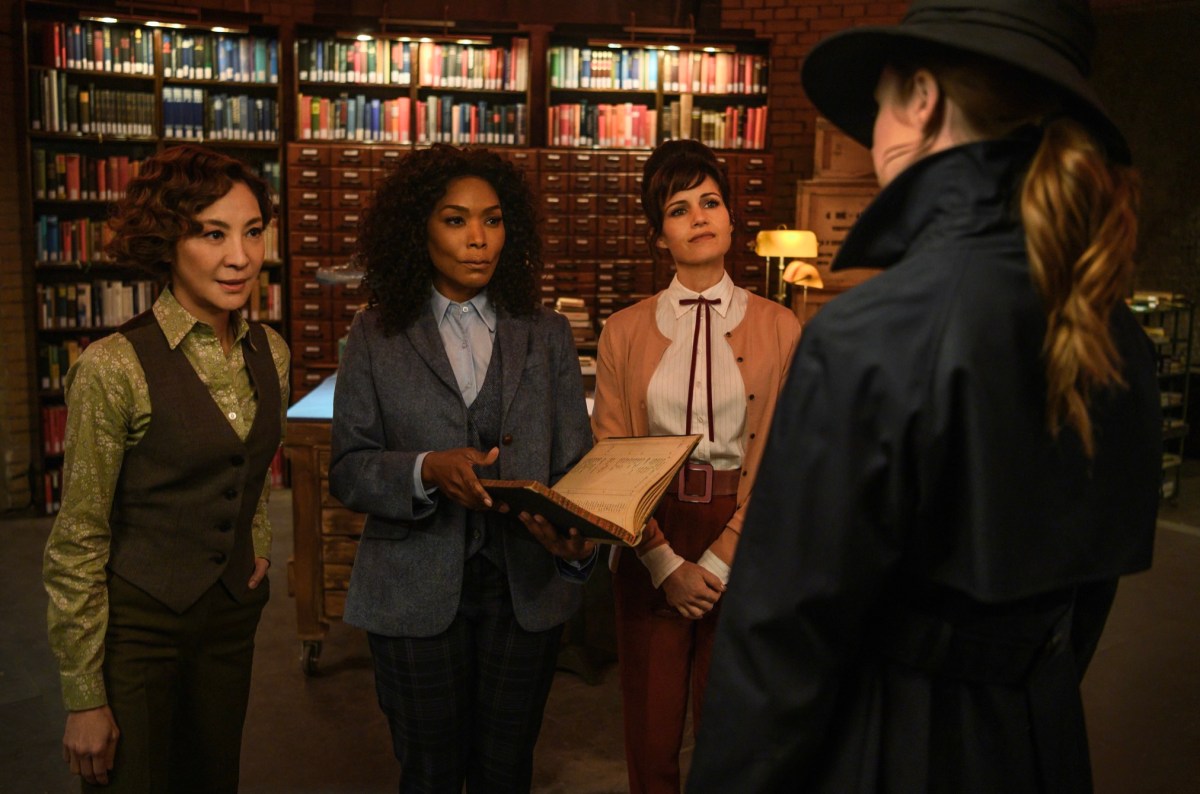 Michelle Yeoh, Angela Bassett, and Carla Gugino are the Librarians, dressed in suits that are green (Yeoh), blue (Bassett), and Pink (Gugino) 