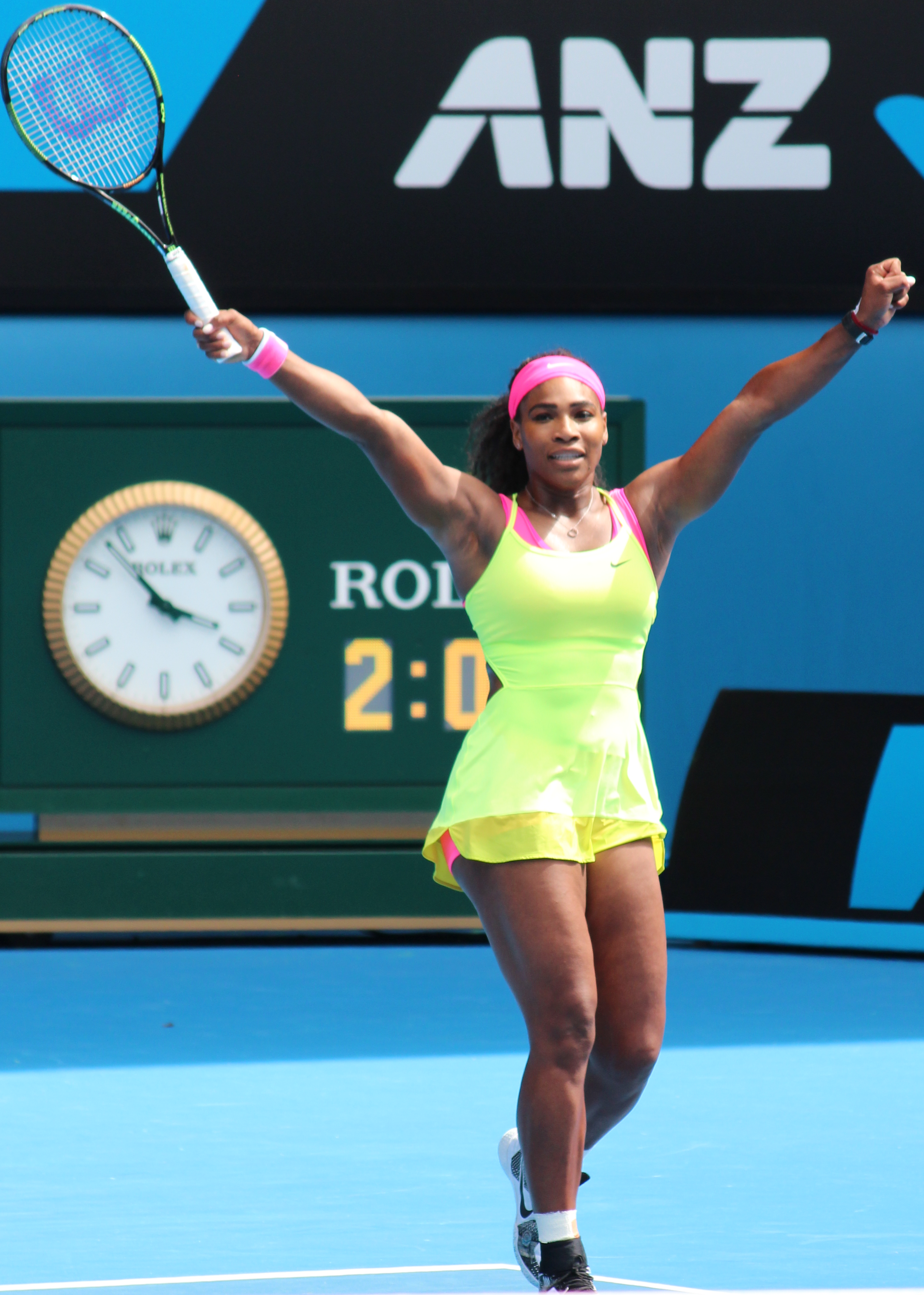 Serena Williams, the greatest athlete of all time, with both arms raised in victory
