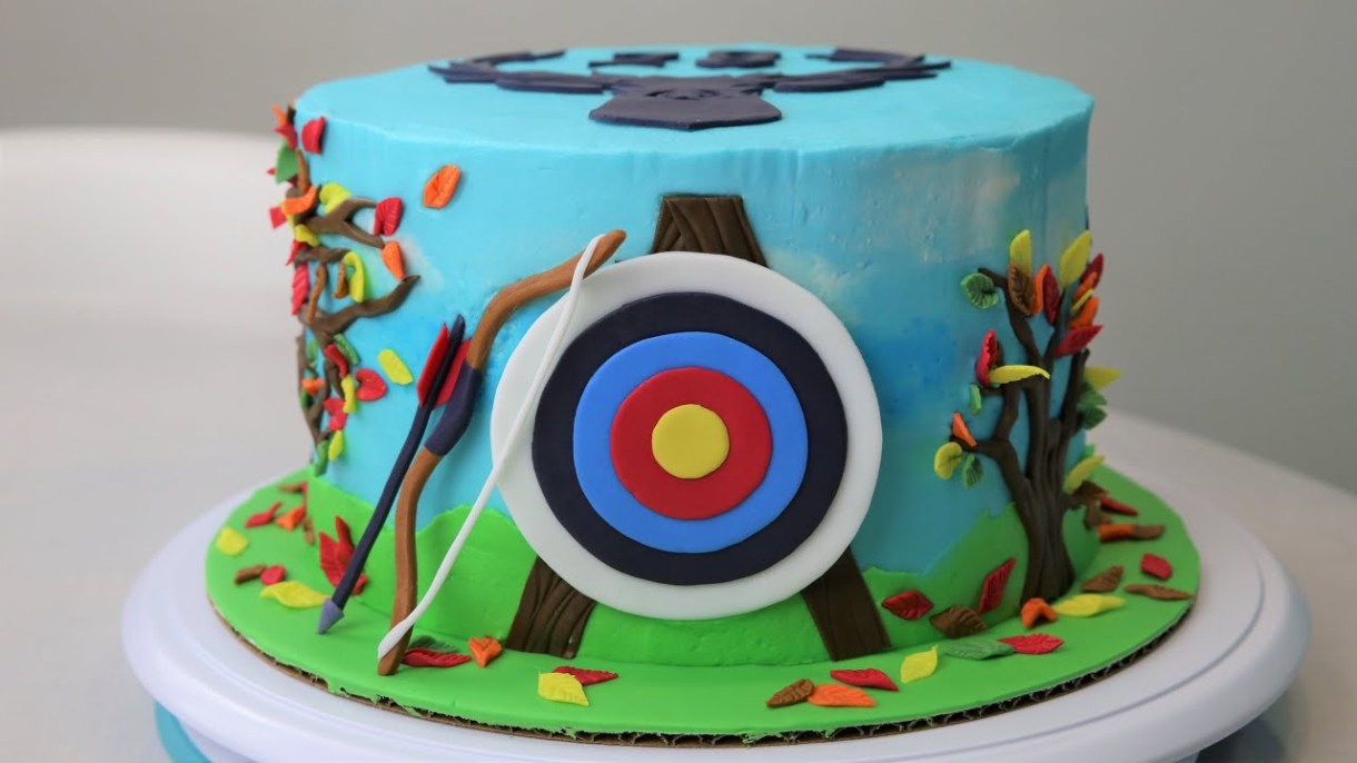 A cake with a decoration of an archery target