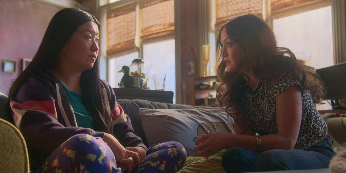 Good Trouble 312: Alice in her pajamas on her couch talking to a supportive Malika