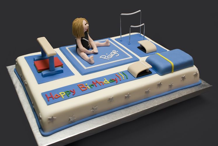 a cake decorated to look like gymnastics equipment