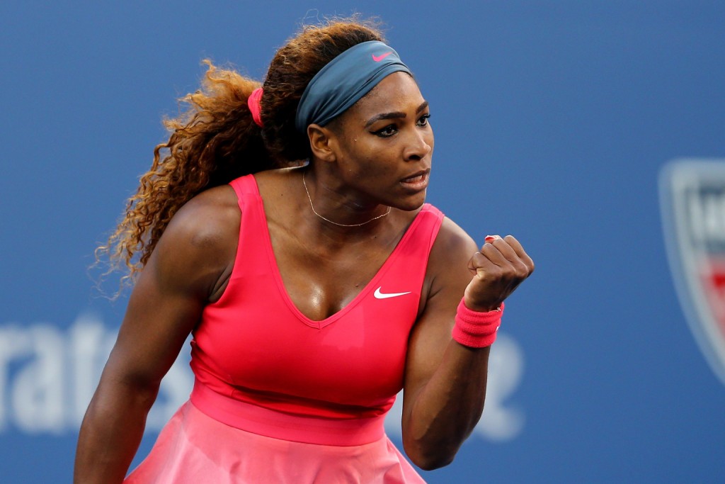 Serena Williams, the greatest athlete of all time, pumping her fist with a look of determination on her face