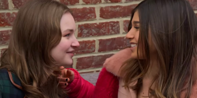 The Bisexual Erasure in My Orthodox Life: Image shows two brunette white women looking into each others eyes.