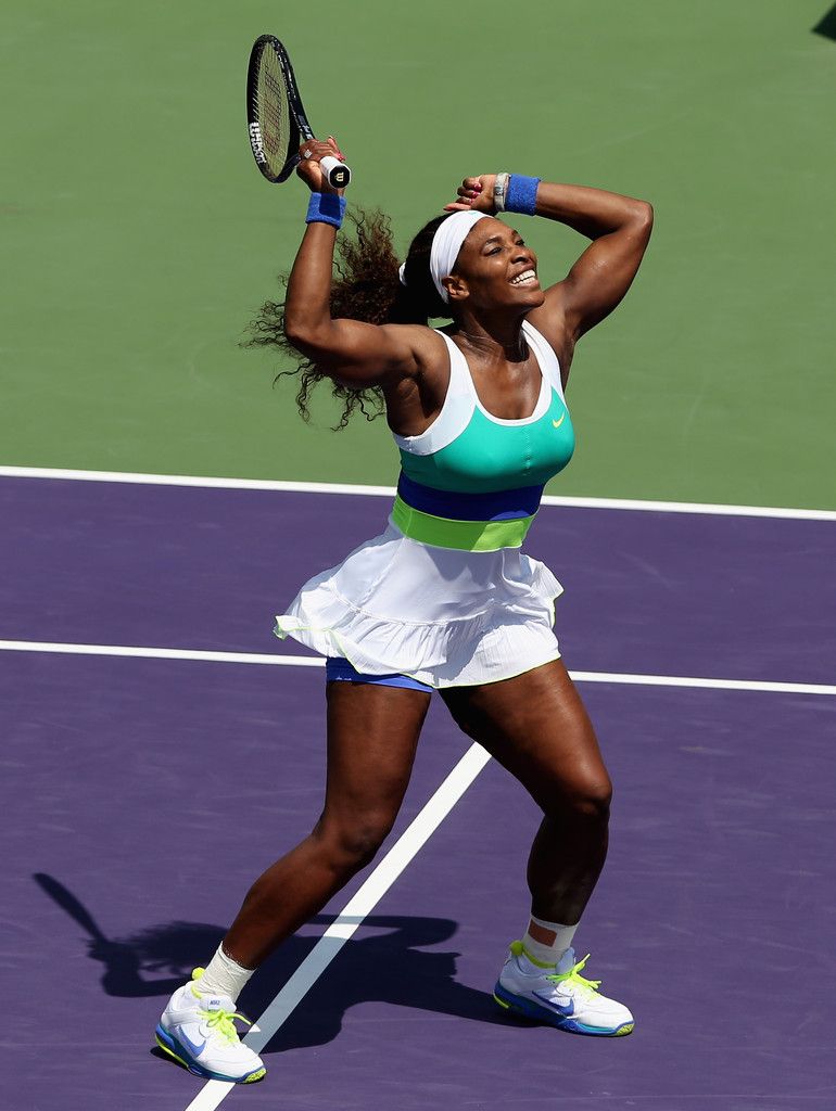 Serena Williams, the greatest athlete of all time, with both arms aloft in victory