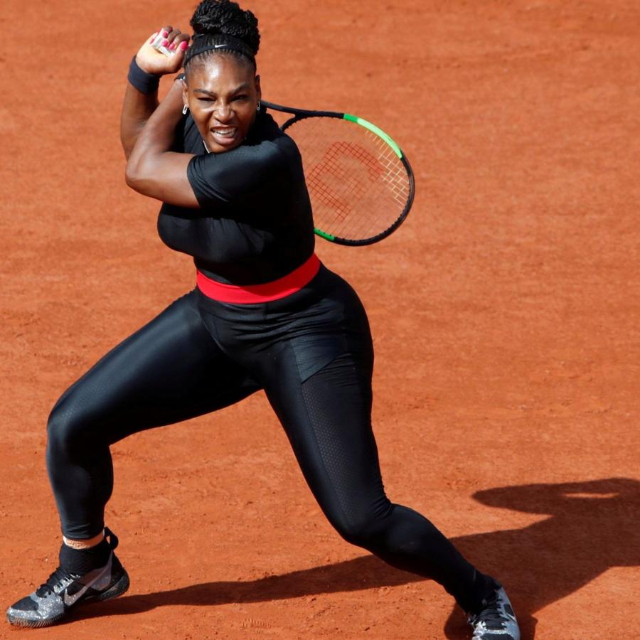 Serena Williams, the greatest athlete of all time, in a black catsuit after returning a shot on the red clay of the French Open