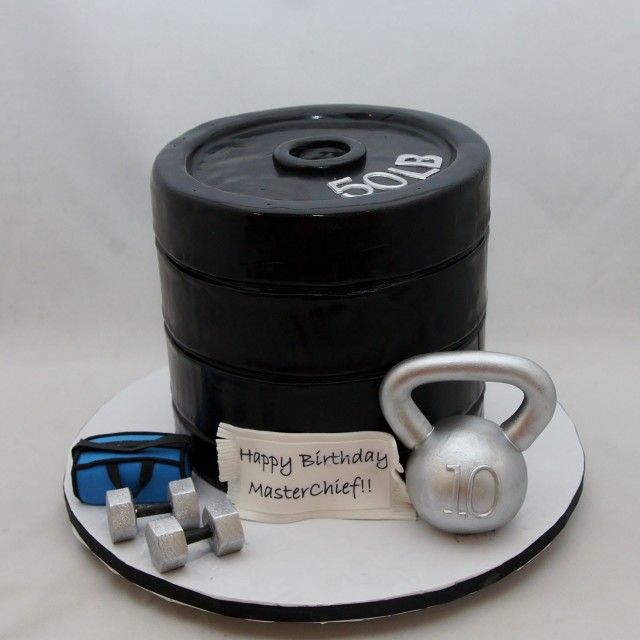 a cake decorated to look like various sorts of weights