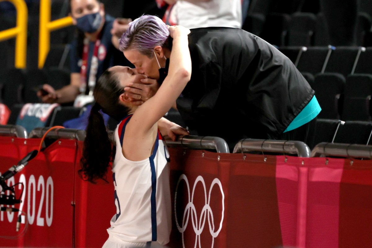 Sue Bird #6 of Team United States kisses Megan Rapinoe in celebration after the United States' win over Japan in the Women's Basketball final game on day sixteen of the 2020 Tokyo Olympic games at Saitama Super Arena on August 08, 2021 