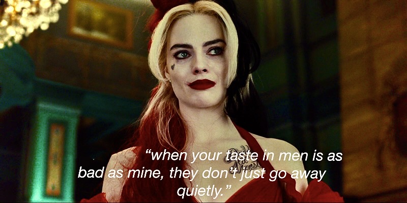 Harley Quinn in "The Suicide Squad" lays the groundwork for a gay future by declaring "when your taste in men is as bad as mine, they don't just go away quietly." She is in a red ball gown with dark red lipstick in a dark mansion.