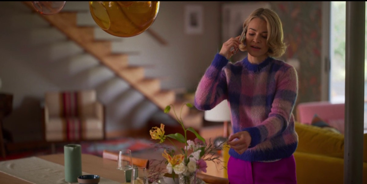 Alice at home touching the flowers in her vase