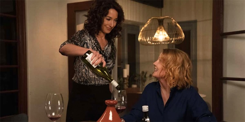 In a screenshot from the first season of The L Word: Generation Q, Bette pours Tina a glass of wine