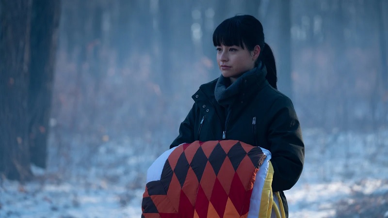 Luna holds a quilt as she participates in her naming ceremony, on the series finale of Burden of Truth.