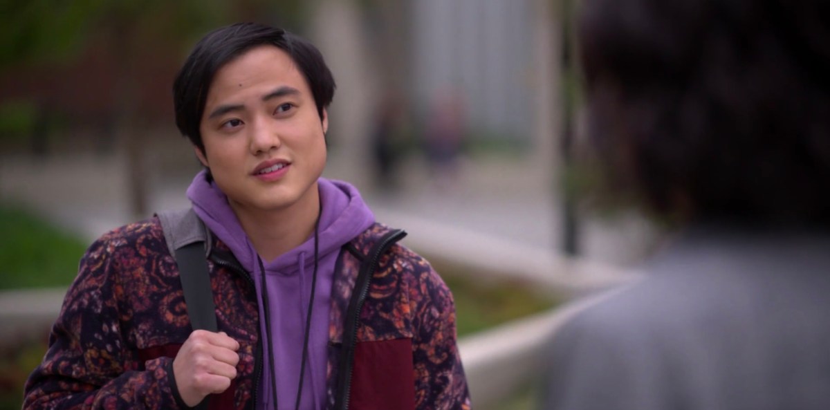 Micah in a purple hoodie outside the LGBT Center