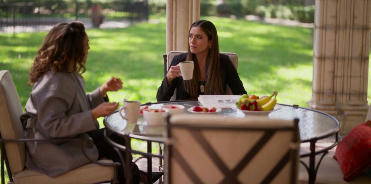 Dani and Gigi sitting down for breakfast in front of a picture window