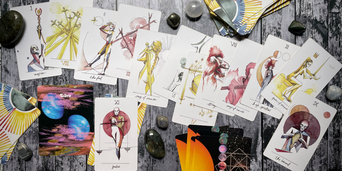 an assortment of tarot cards from the vindur deck, along with crystals