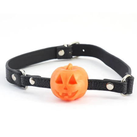 A black, faux leather ball gag (but the "ball" is a silicone orange jack-o-lantern)