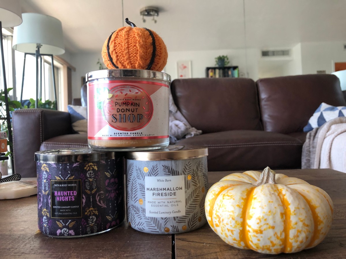 A towering stack of candles along with decorative gourd