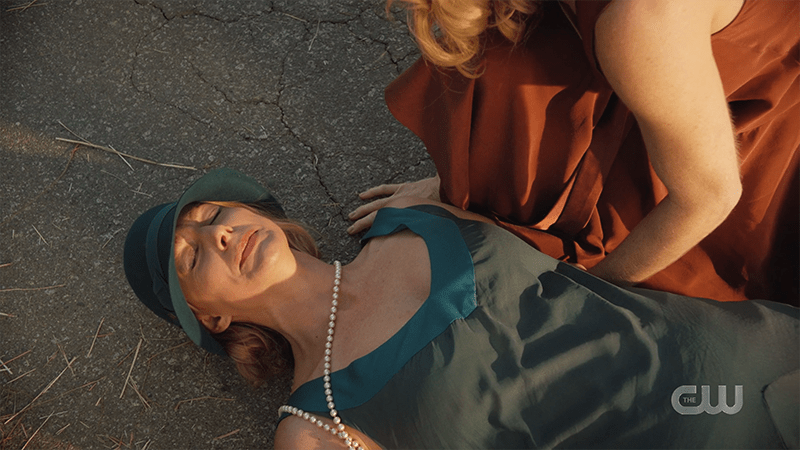 Ava lies dramatically on the ground