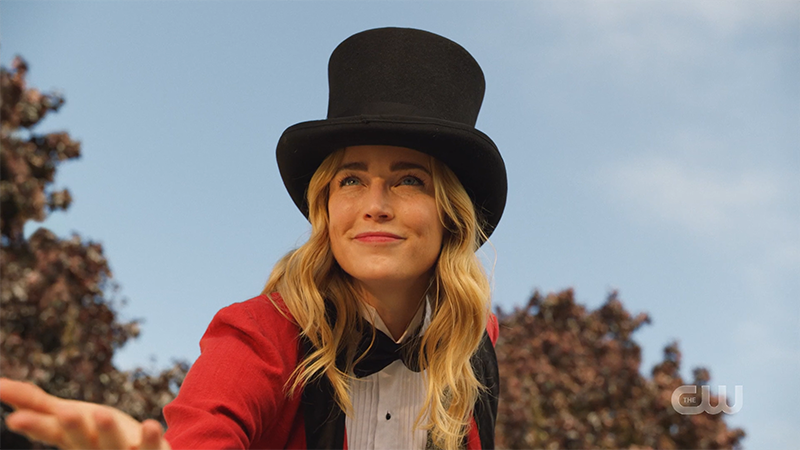 Sara in a top hat being charming