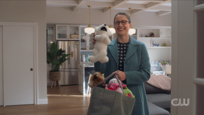 Supergirl recap 615: Kara beams as she holds up a stuffed animal