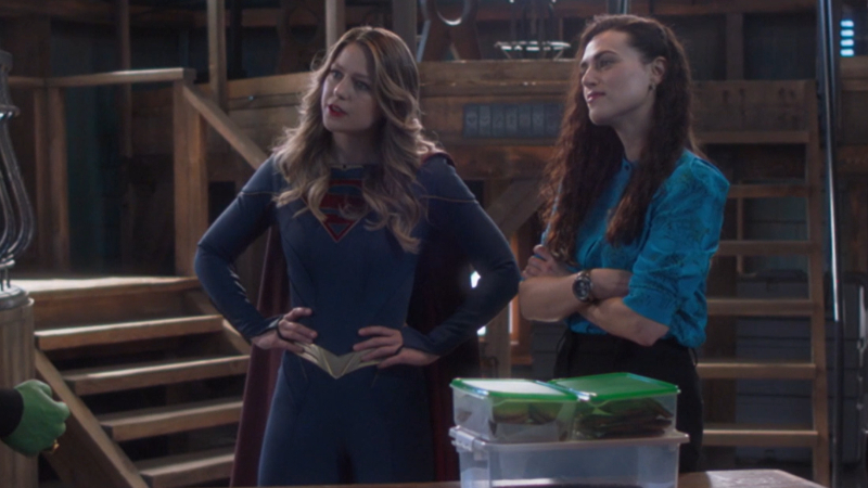 Kara and Lena stand in their power poses and listen to brainy
