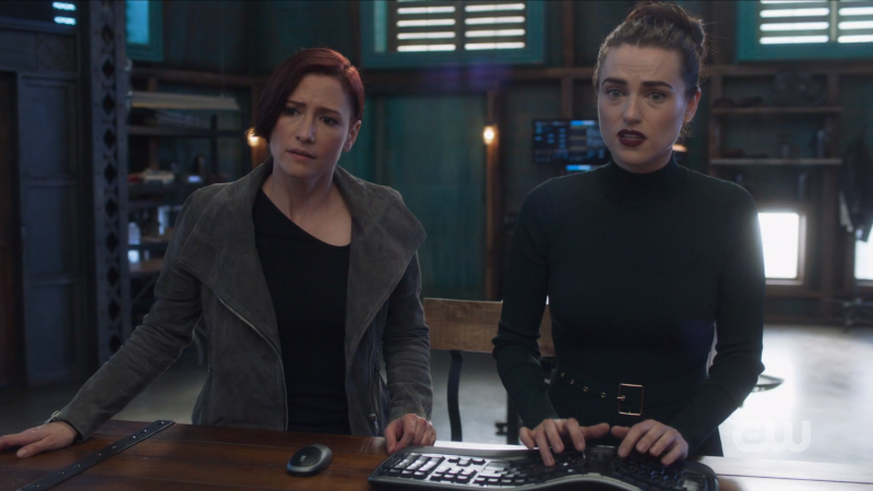Alex and Lena stand side by side doing science