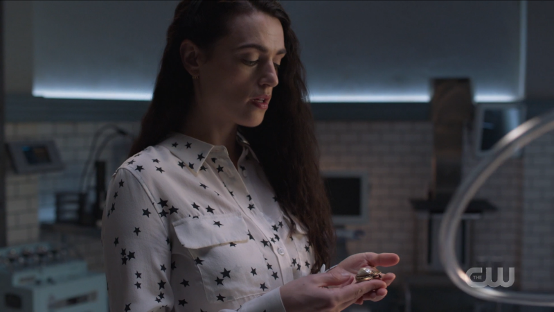 Lena does magic in a cute white button down with stars on it