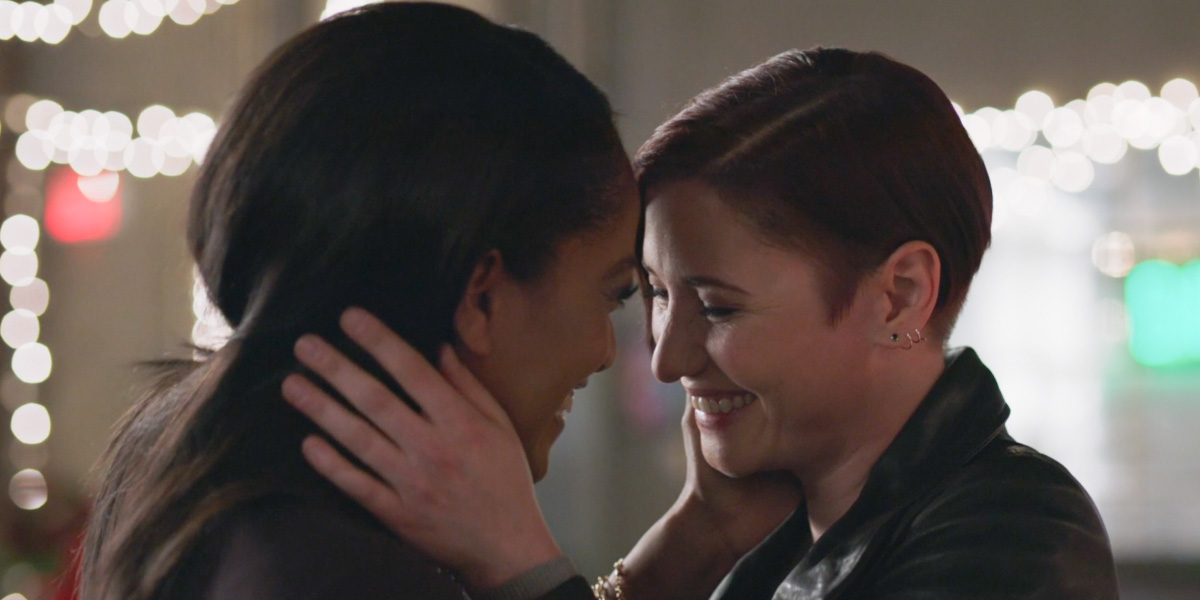 Screenshot from Supergirl episode 617 of Alex Danvers and Kelly Olsen smiling post kiss