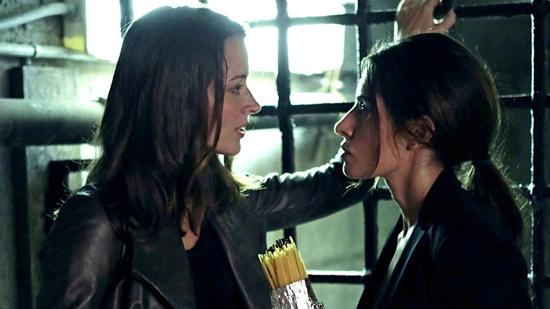 best lesbian sci-fi fantasy tv shows: root and shaw stand close and stare at each other