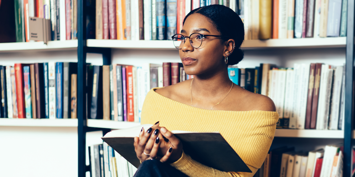 reading, against bookshelves