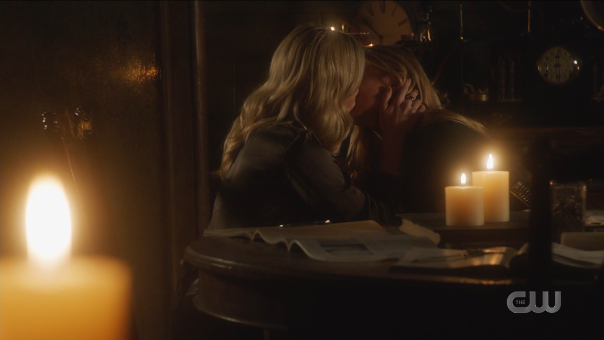 Ava and Sara aka Avalance kiss surrounded by candles