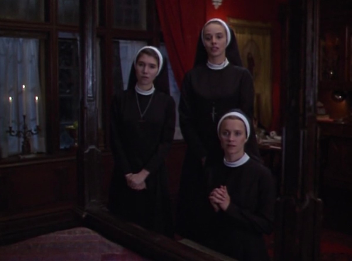 Three nuns kneeling at a bad
