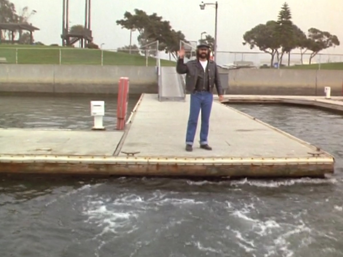 George waves goodbye from the dock