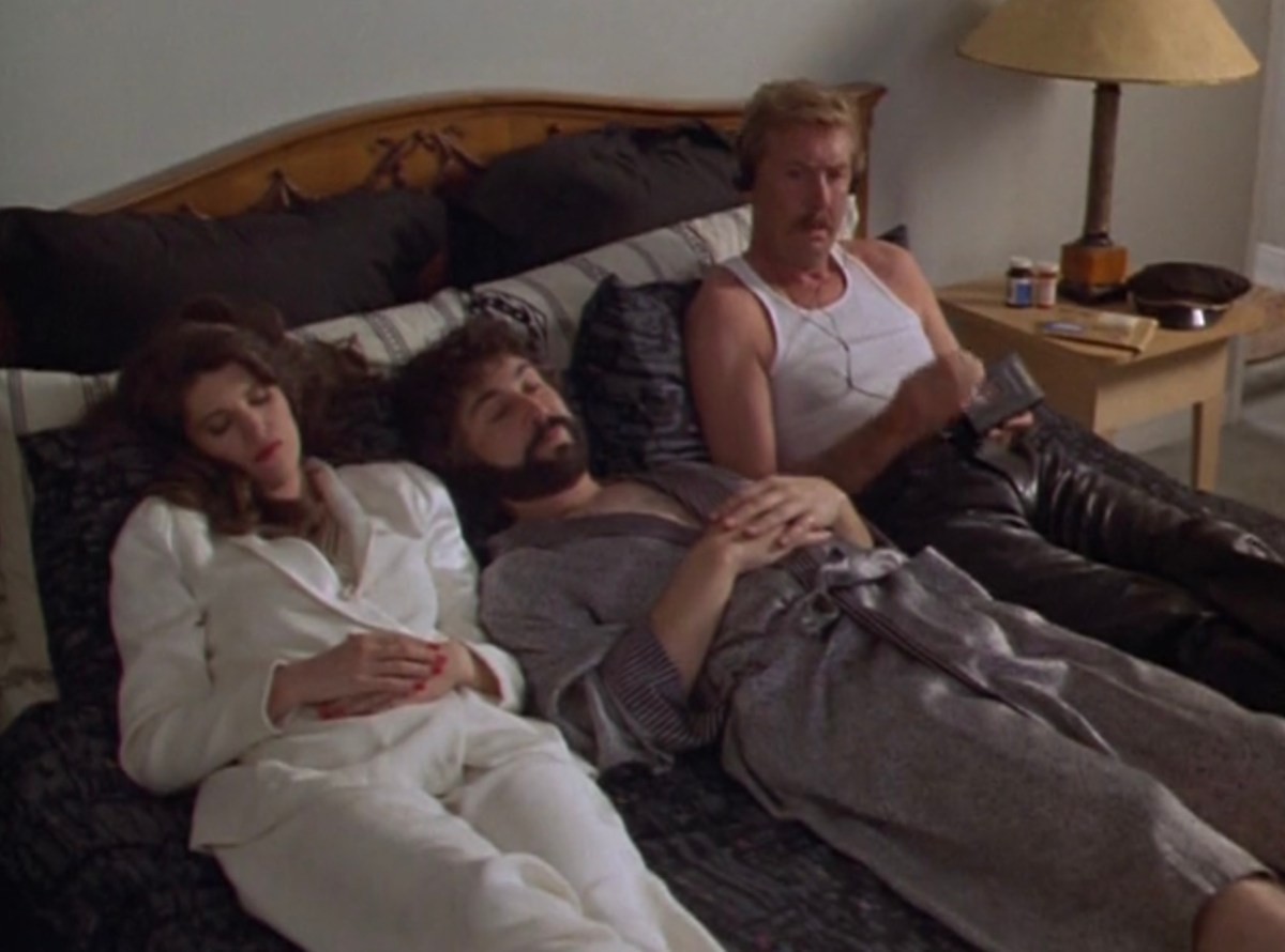 Susan, George and Sonny in bed, Sonny listening to the tape