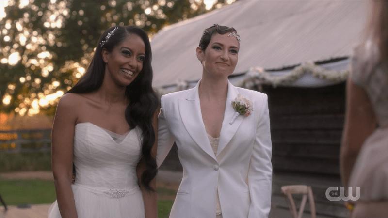 Kelly and Alex smile in their wedding garb